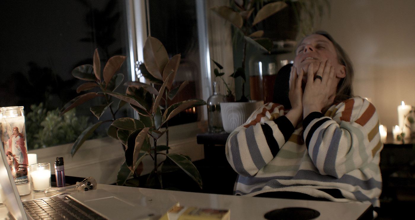 Abbey leans back by candlelight, smiling.